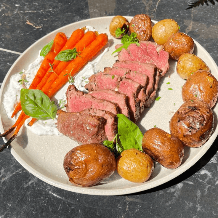 Filet mignon with herb crème fraîche, potatoes and carrots